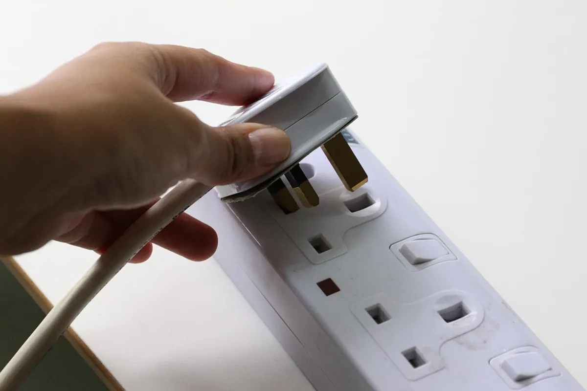 A UK three-pin plug and extension sockets